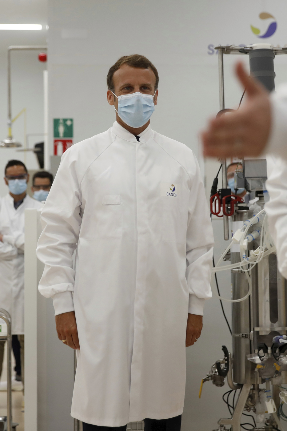French President Emmanuel Macron visits an industrial development laboratory at the French drugmaker's vaccine unit Sanofi Pasteur plant in Marcy-l'Etoile, near Lyon, central France, Tuesday, June 16, 2020. The visit comes after rival pharmaceutical company AstraZeneca this weekend announced a deal to supply 400 million vaccine doses to EU countries, including France. (Gonzalo Fuentes/Pool via AP)