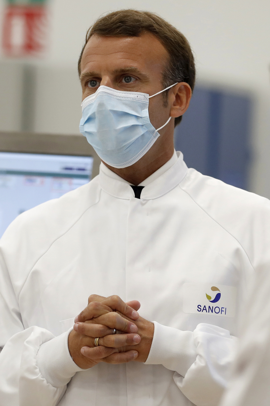 French President Emmanuel Macron visits an industrial development laboratory at the French drugmaker's vaccine unit Sanofi Pasteur plant in Marcy-l'Etoile, near Lyon, central France, Tuesday, June 16, 2020. The visit comes after rival pharmaceutical company AstraZeneca this weekend announced a deal to supply 400 million vaccine doses to EU countries, including France. (Gonzalo Fuentes/Pool via AP)