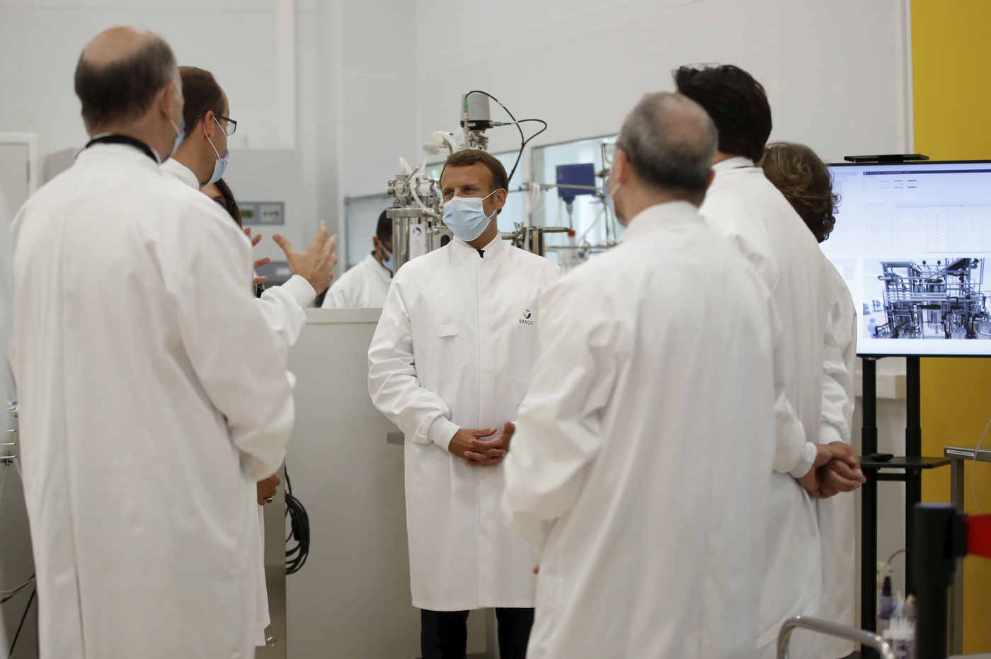 French President Emmanuel Macron visits an industrial development laboratory at the French drugmaker's vaccine unit Sanofi Pasteur plant in Marcy-l'Etoile, near Lyon, central France, Tuesday, June 16, 2020. The visit comes after rival pharmaceutical company AstraZeneca this weekend announced a deal to supply 400 million vaccine doses to EU countries, including France. (Gonzalo Fuentes/Pool via AP)