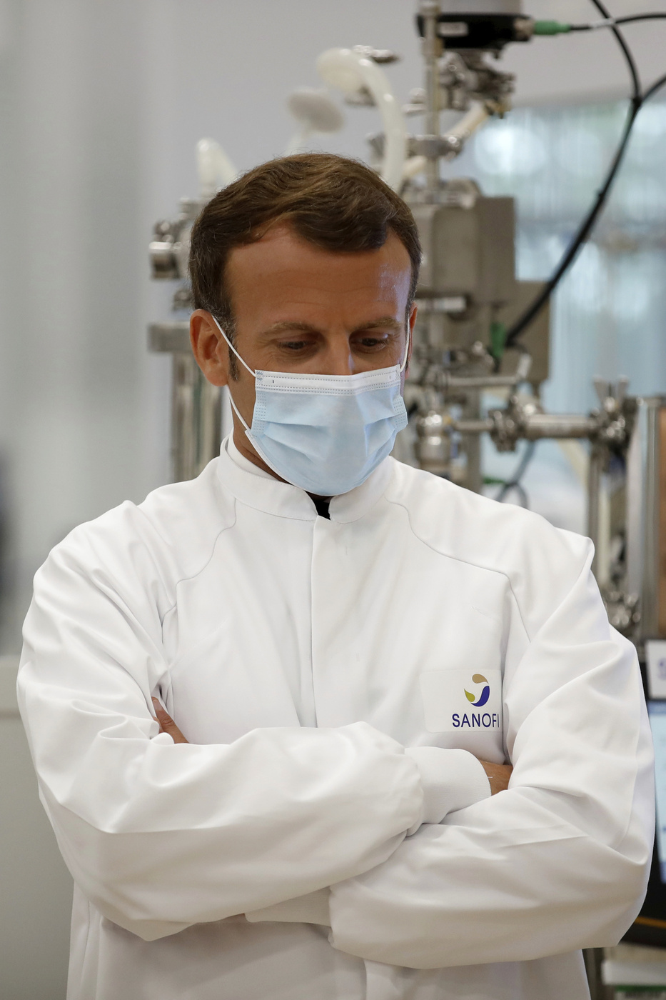 French President Emmanuel Macron visits an industrial development laboratory at the French drugmaker's vaccine unit Sanofi Pasteur plant in Marcy-l'Etoile, near Lyon, central France, Tuesday, June 16, 2020. The visit comes after rival pharmaceutical company AstraZeneca this weekend announced a deal to supply 400 million vaccine doses to EU countries, including France. (Gonzalo Fuentes/Pool via AP)