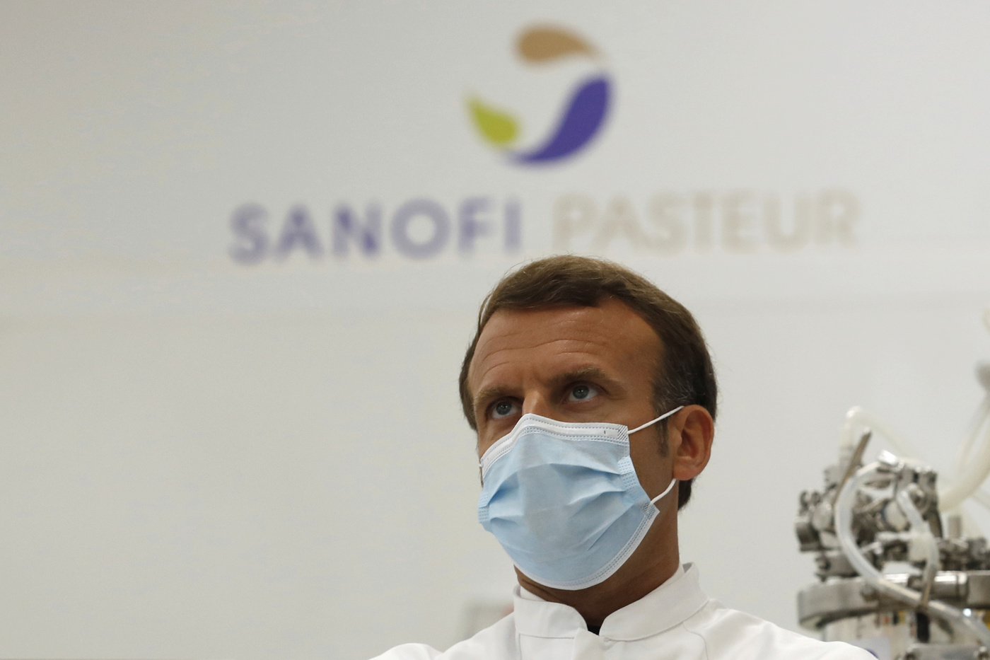 French President Emmanuel Macron visits an industrial development laboratory at the French drugmaker's vaccine unit Sanofi Pasteur plant in Marcy-l'Etoile, near Lyon, central France, Tuesday, June 16, 2020. The visit comes after rival pharmaceutical company AstraZeneca this weekend announced a deal to supply 400 million vaccine doses to EU countries, including France. (Gonzalo Fuentes/Pool via AP)