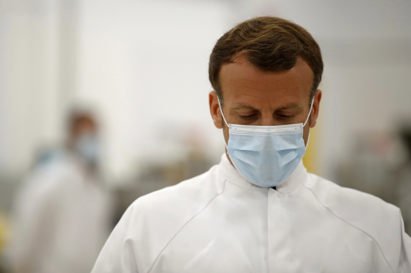 French President Emmanuel Macron, wearing a protective face mask, visits an industrial development laboratory at the French drugmaker's vaccine unit Sanofi Pasteur plant in Marcy-l'Etoile, near Lyon, central France, Tuesday, June 16, 2020. The visit comes after rival pharmaceutical company AstraZeneca this weekend announced a deal to supply 400 million vaccine doses to EU countries, including France. (Gonzalo Fuentes/Pool via AP)