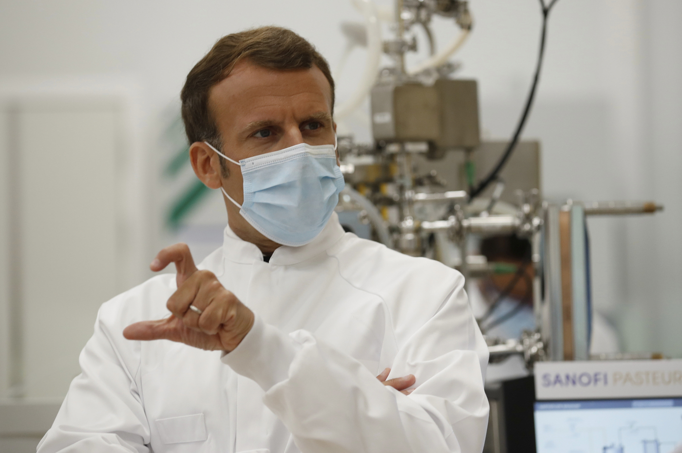 French President Emmanuel Macron visits an industrial development laboratory at the French drugmaker's vaccine unit Sanofi Pasteur plant in Marcy-l'Etoile, near Lyon, central France, Tuesday, June 16, 2020. The visit comes after rival pharmaceutical company AstraZeneca this weekend announced a deal to supply 400 million vaccine doses to EU countries, including France. (Gonzalo Fuentes/Pool via AP)