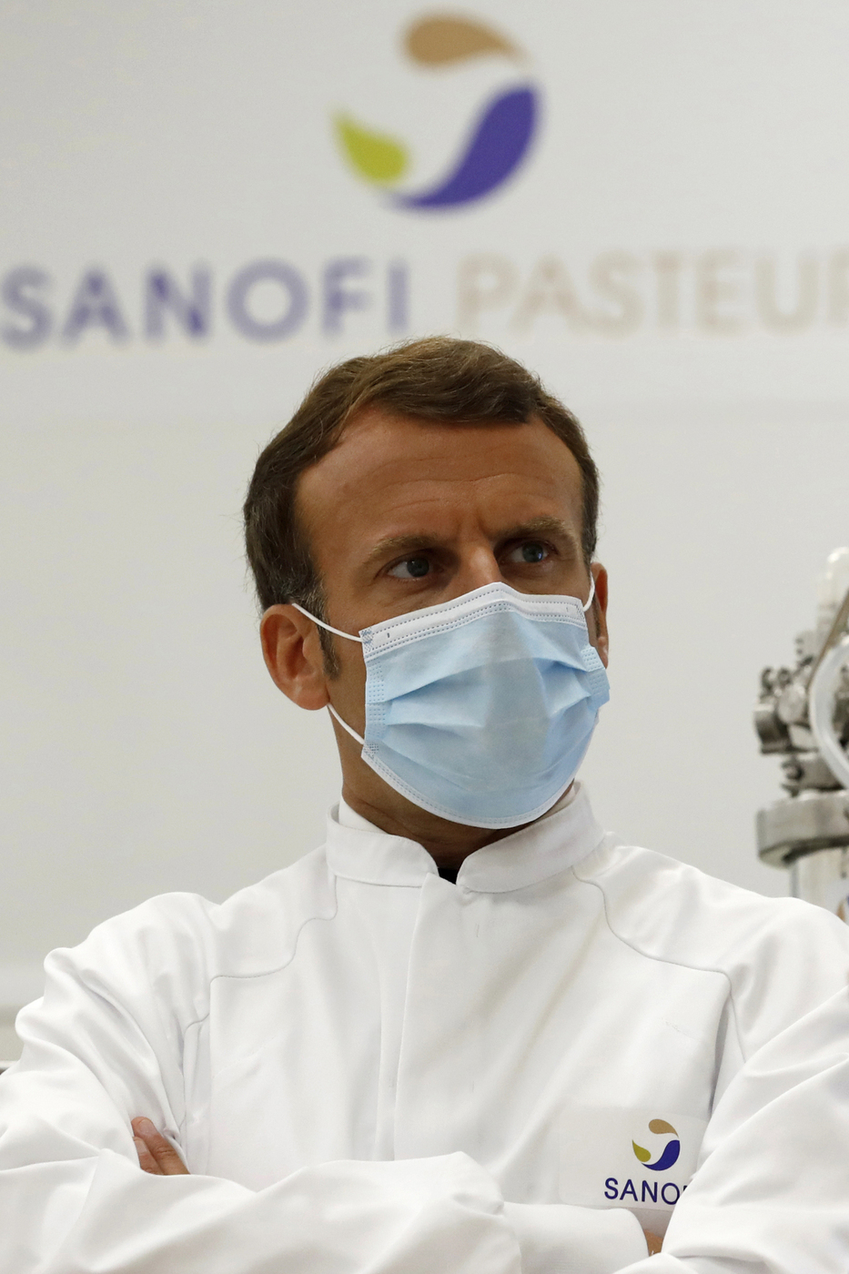 French President Emmanuel Macron, wearing a protective face mask, visits an industrial development laboratory at the French drugmaker's vaccine unit Sanofi Pasteur plant in Marcy-l'Etoile, near Lyon, central France, Tuesday, June 16, 2020. The visit comes after rival pharmaceutical company AstraZeneca this weekend announced a deal to supply 400 million vaccine doses to EU countries, including France. (Gonzalo Fuentes/Pool via AP)