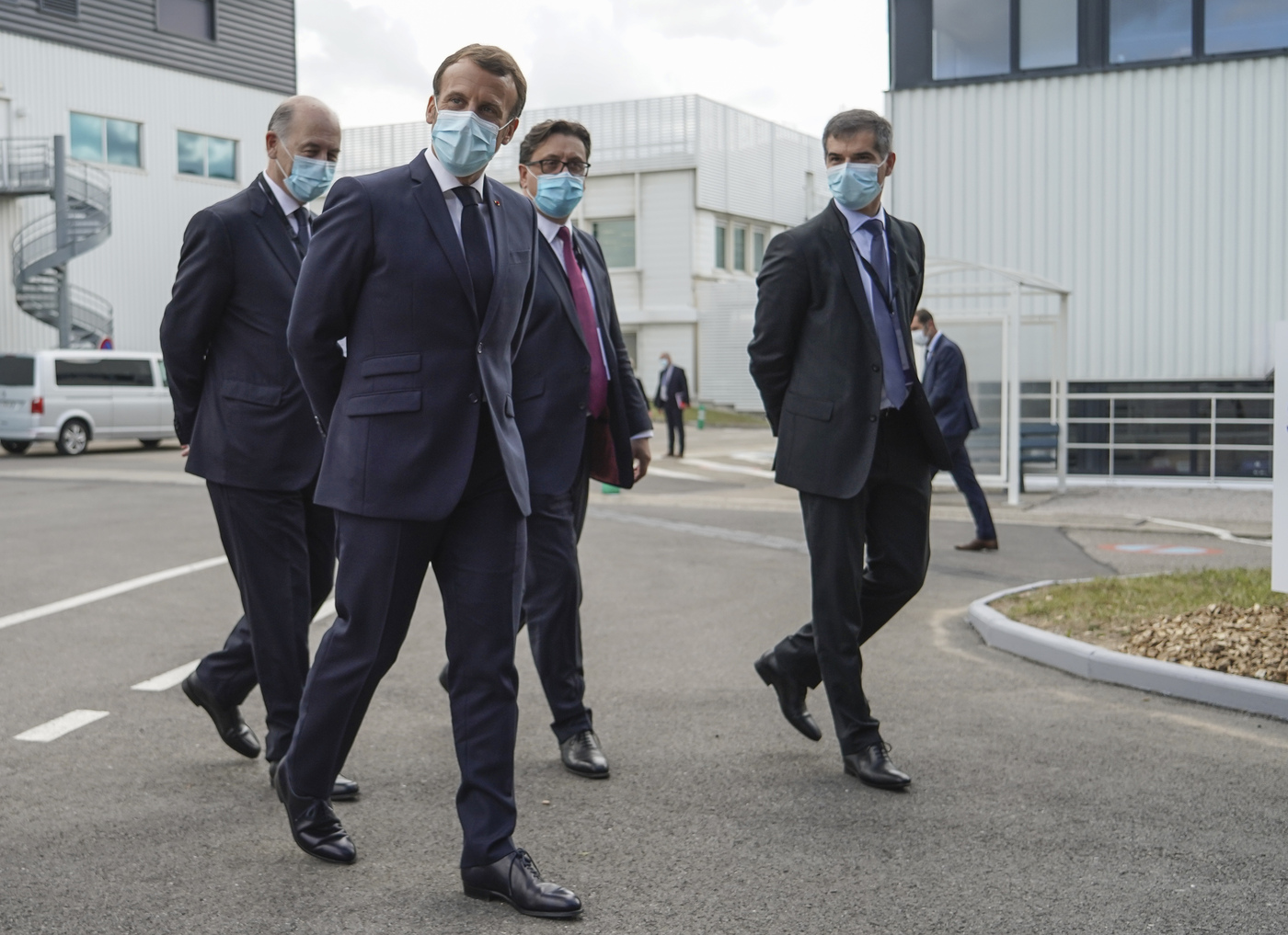 From left to right, Board Director of Sanofi Serge Weinberg, French President Emmanuel Macron, CEO of Sanofi Paul Hudson, and President of Sanofi France Olivier Bogillot arrive at the French drugmaker's vaccine unit Sanofi Pasteur plant in Marcy-l'Etoile, near Lyon, central France, Tuesday, June 16, 2020.The visit comes after rival pharmaceutical company AstraZeneca this weekend announced a deal to supply 400 million vaccine doses to EU countries, including France. (AP Photo/Laurent Cipriani, Pool)