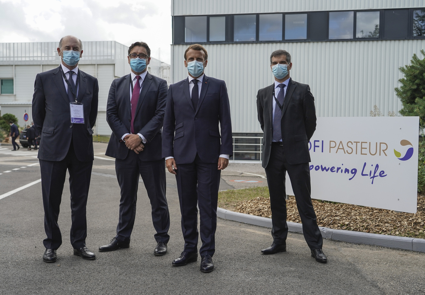 From left to right, Board Director of Sanofi Serge Weinberg, CEO of Sanofi Paul Hudson, French President Emmanuel Macron and President of Sanofi France Olivier Bogillot pose for a group photo at the French drugmaker's vaccine unit Sanofi Pasteur plant in Marcy-l'Etoile, near Lyon, central France, Tuesday, June 16, 2020.The visit comes after rival pharmaceutical company AstraZeneca this weekend announced a deal to supply 400 million vaccine doses to EU countries, including France. (AP Photo/Laurent Cipriani, Pool)