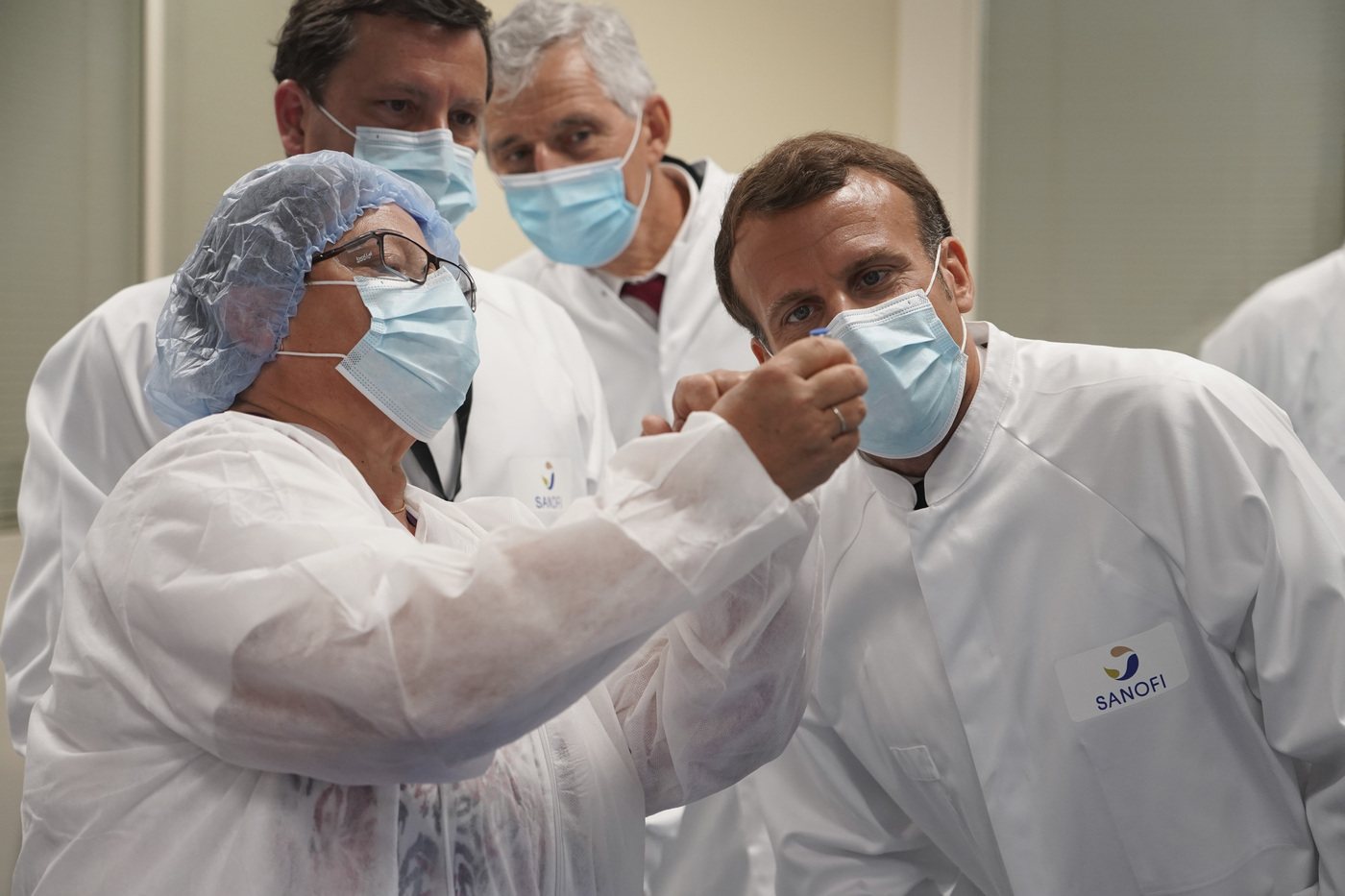 French President Emmanuel Macron visits an industrial development laboratory at French drugmaker's vaccine unit Sanofi Pasteur plant in Marcy-l'Etoile, near Lyon, central France, Tuesday, June 16, 2020.The visit comes after rival pharmaceutical company AstraZeneca this weekend announced a deal to supply 400 million vaccine doses to EU countries, including France. (AP Photo/Laurent Cipriani, Pool)