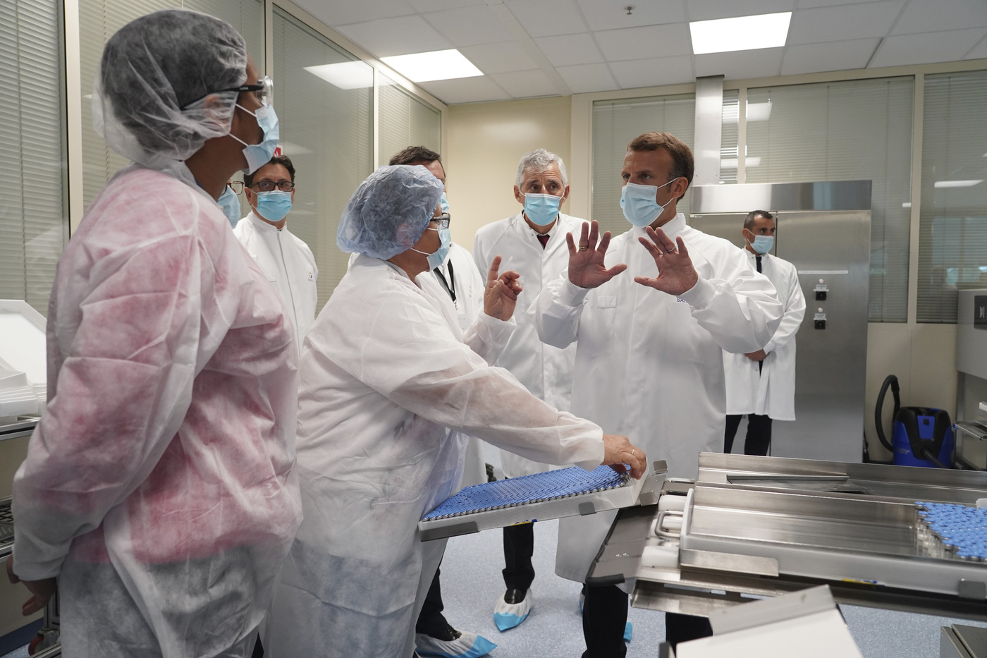 French President Emmanuel Macron talks to a group of esearchers as he visits an industrial development laboratory at French drugmaker's vaccine unit Sanofi Pasteur plant in Marcy-l'Etoile, near Lyon, central France, Tuesday, June 16, 2020.The visit comes after rival pharmaceutical company AstraZeneca this weekend announced a deal to supply 400 million vaccine doses to EU countries, including France. (AP Photo/Laurent Cipriani, Pool)