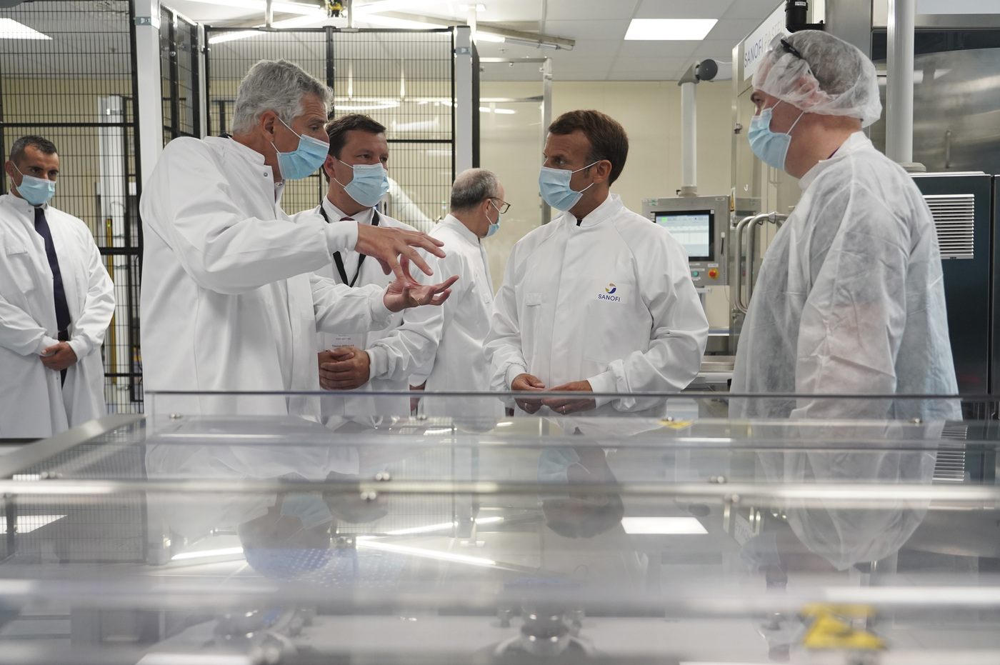 French President Emmanuel Macron listens to a researcher as he visits an industrial development laboratory at French drugmaker's vaccine unit Sanofi Pasteur plant in Marcy-l'Etoile, near Lyon, central France, Tuesday, June 16, 2020.The visit comes after rival pharmaceutical company AstraZeneca this weekend announced a deal to supply 400 million vaccine doses to EU countries, including France. (AP Photo/Laurent Cipriani, Pool)