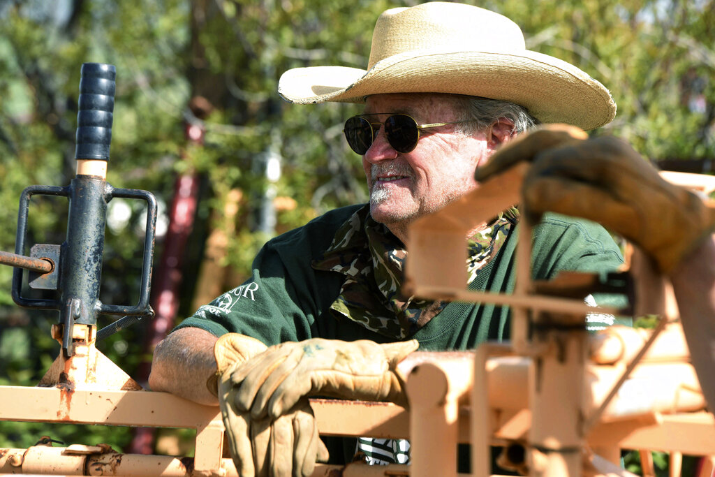 In this Thursday, May 28, 2020, photograph, Hobey Early looks on during branding at the Stanko Ranch outside Steamboat Springs, Colo. (John Russell/Steamboat Pilot & Today via AP)