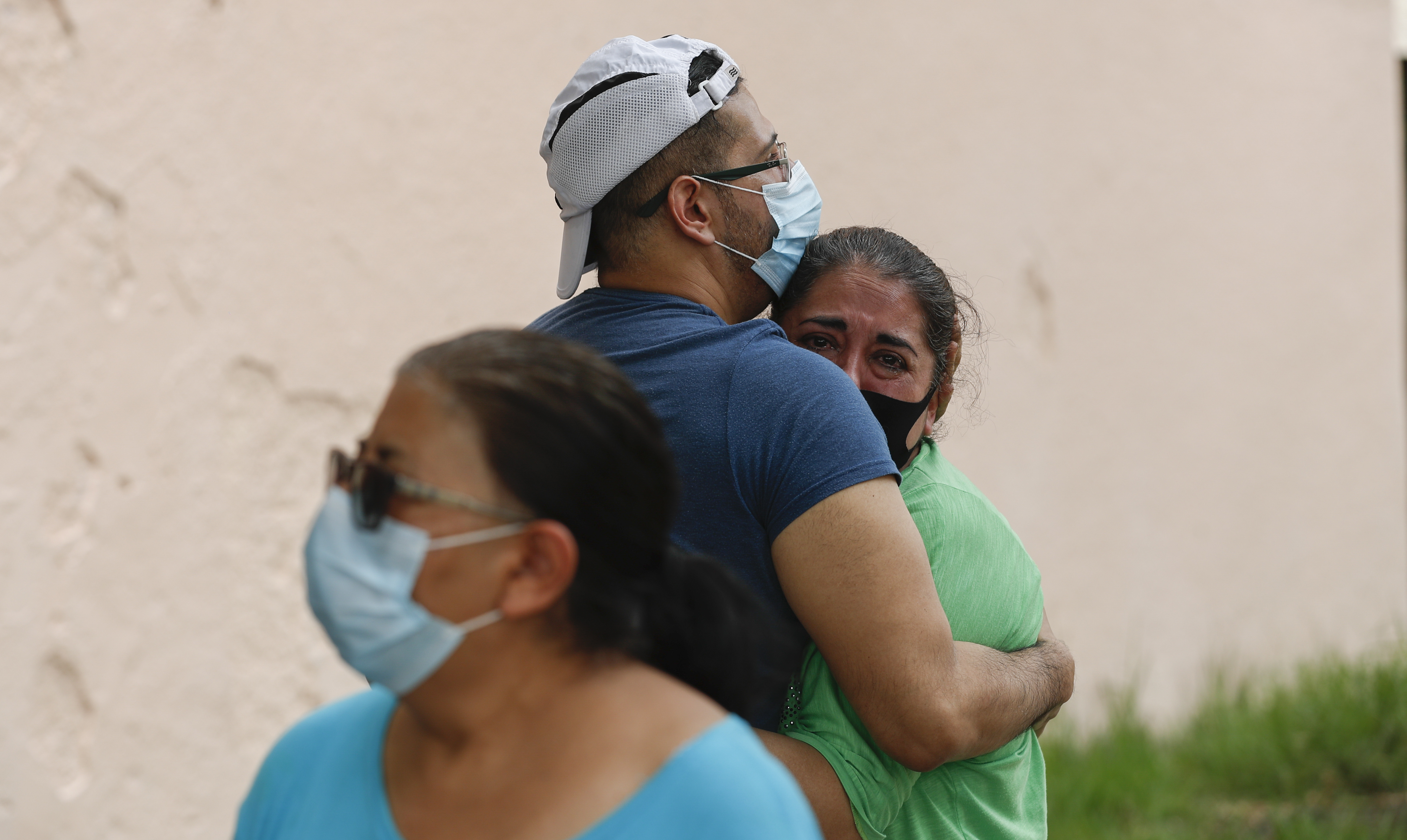 A couple embraces outside their home as they wait for the all-clear to return to their apartment, after an earthquake in Mexico City, Tuesday, June 23, 2020. The earthquake struck near the Huatulco resort in southern Mexico on Tuesday morning, swayed buildings in Mexico City and sent thousands fleeing into the streets. (AP Photo/Eduardo Verdugo)