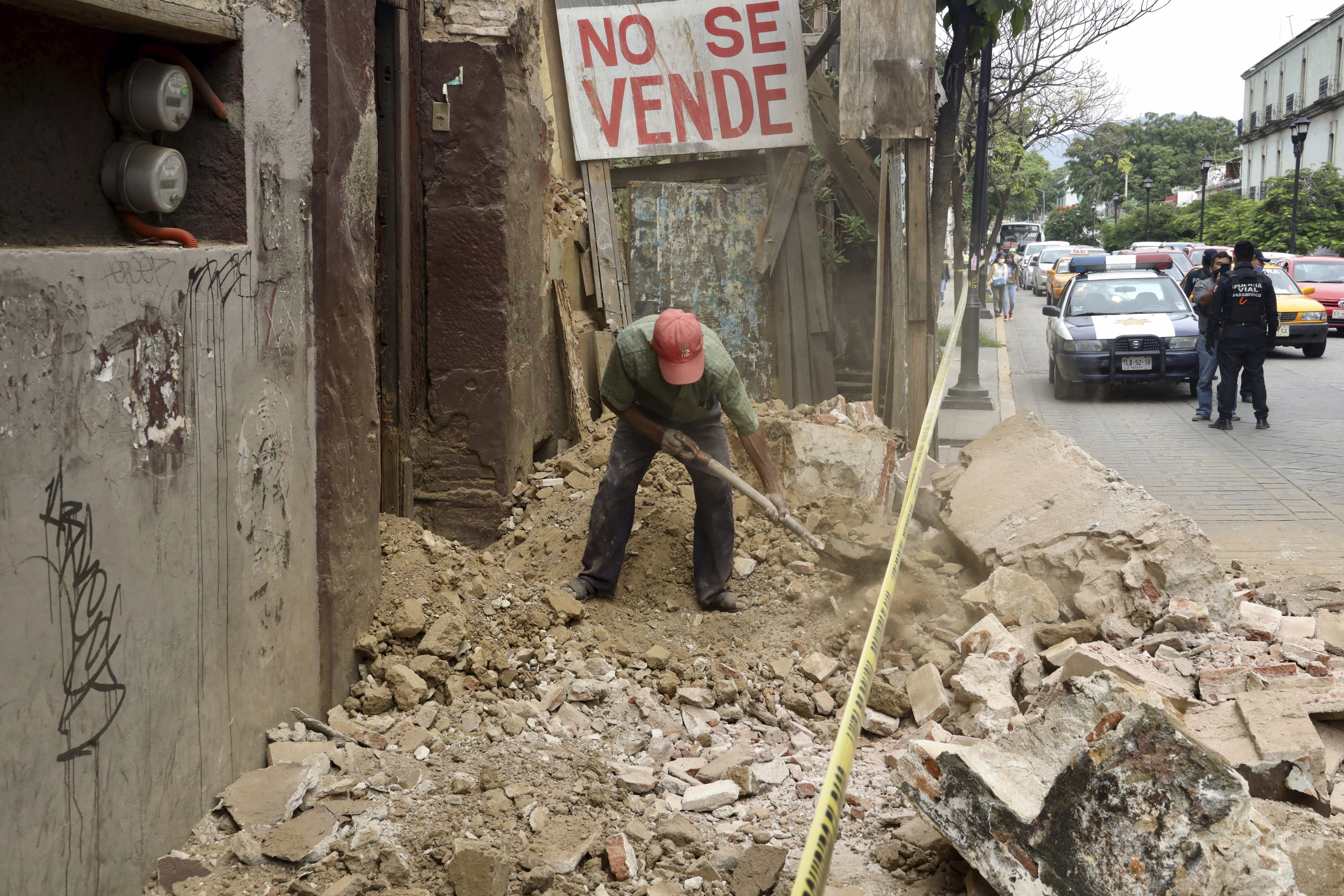 A man removes rubble from a building damaged by an earthquake in Oaxaca, Mexico, Tuesday, June 23, 2020. (AP Photo/Luis Alberto Cruz Hernandez)