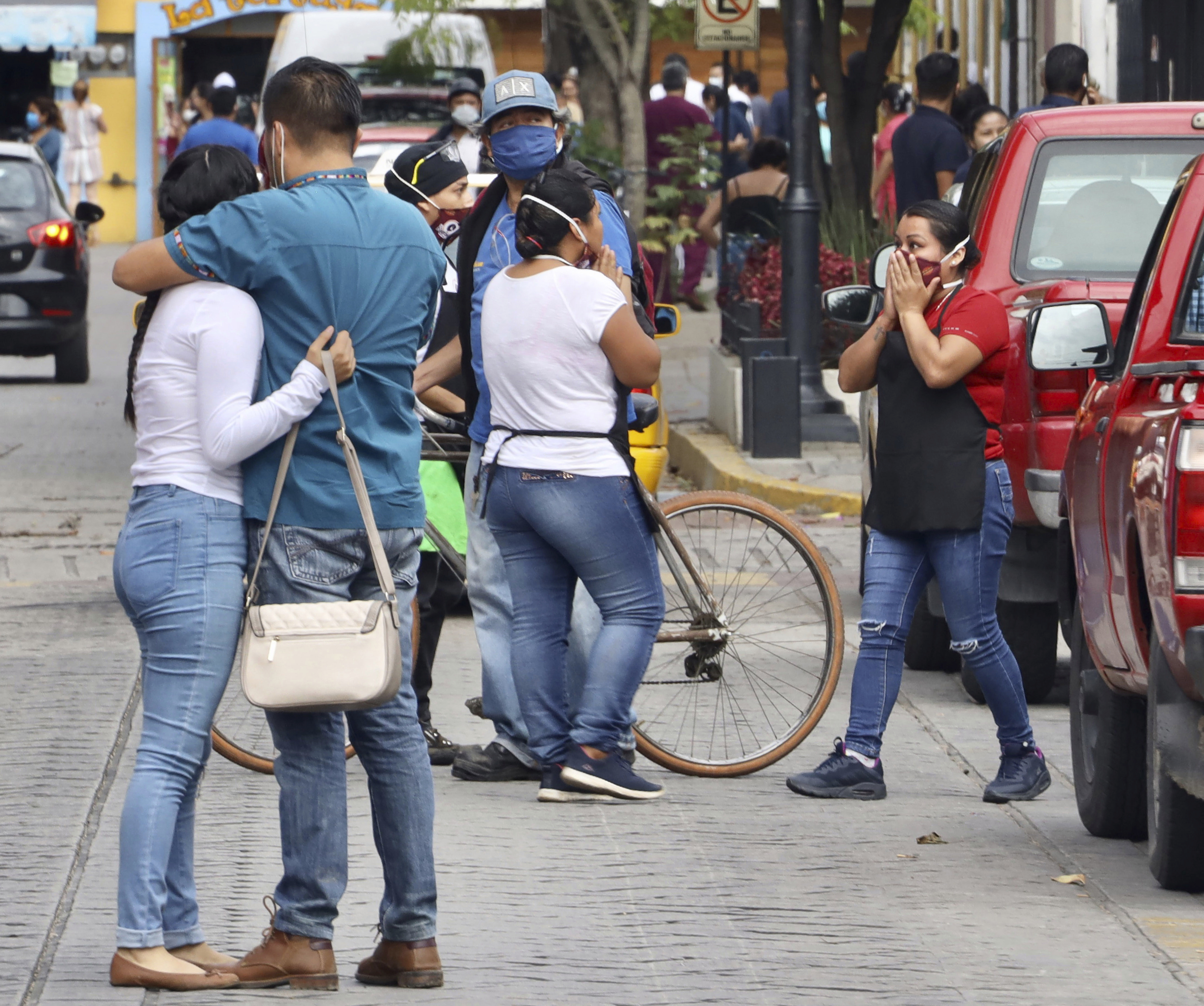 People react after a 7.7 earthquake in Oaxaca, Mexico, Tuesday, June 23, 2020. The earthquake centered near the resort of Huatulco in southern Mexico swayed buildings in Mexico City and sent thousands into the streets. (AP Photo/Luis Alberto Cruz Hernandez)