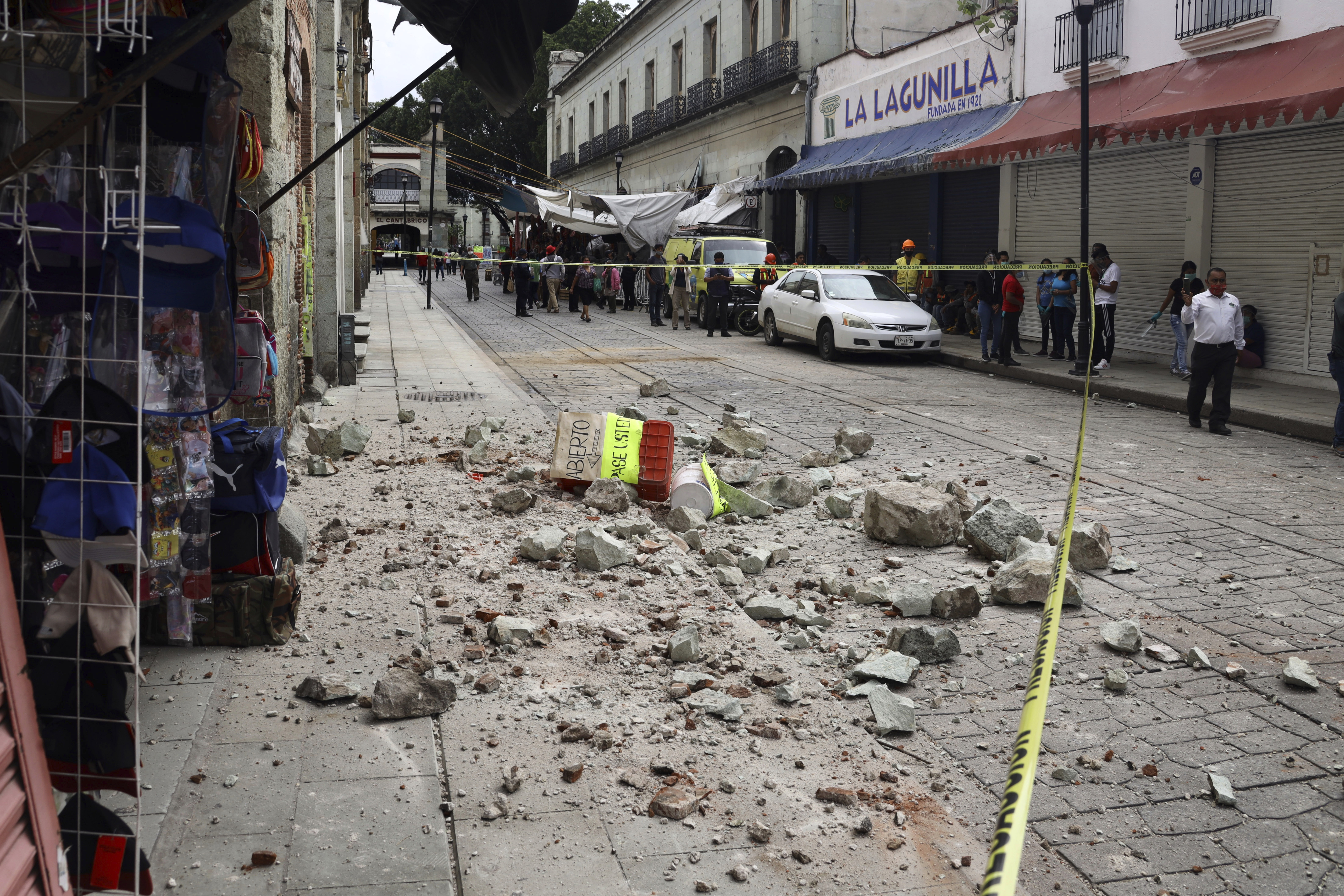 Security tape alert people of a building damaged by an earthquake in Oaxaca, Mexico, Tuesday, June 23, 2020.  The earthquake was centered near the resort of Huatulco, in the southern state of Oaxaca. (AP Photo/Luis Alberto Cruz Hernandez)