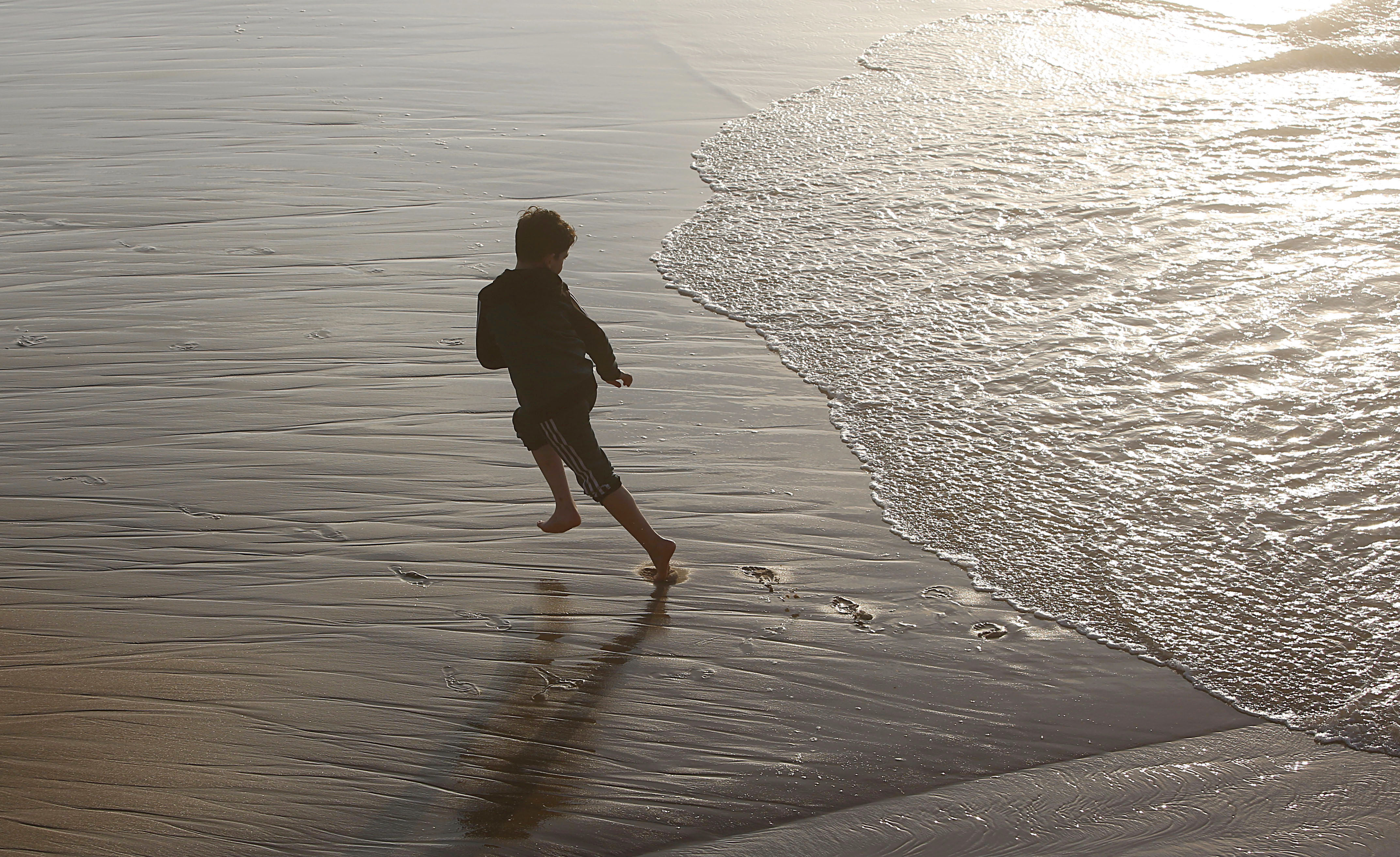 A boy plays on a beach in Gaza City, Saturday, Feb.22, 2020. The beach is one of the few open public spaces in this densely populated city. (AP Photo/Hatem Moussa)