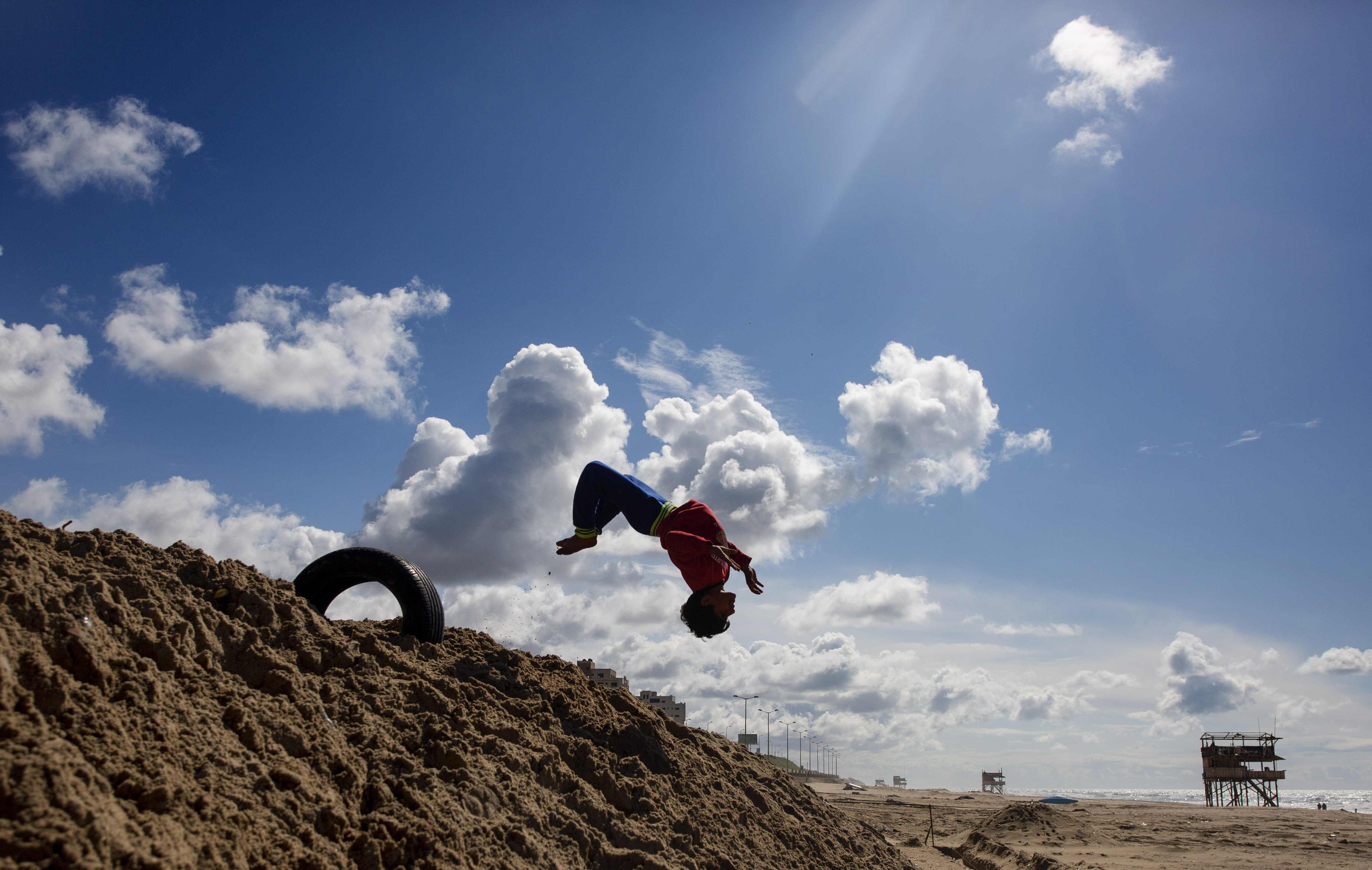 Palestinian children play on the beach of Gaza city, Saturday, March 21, 2020. (AP Photo/Khalil Hamra)