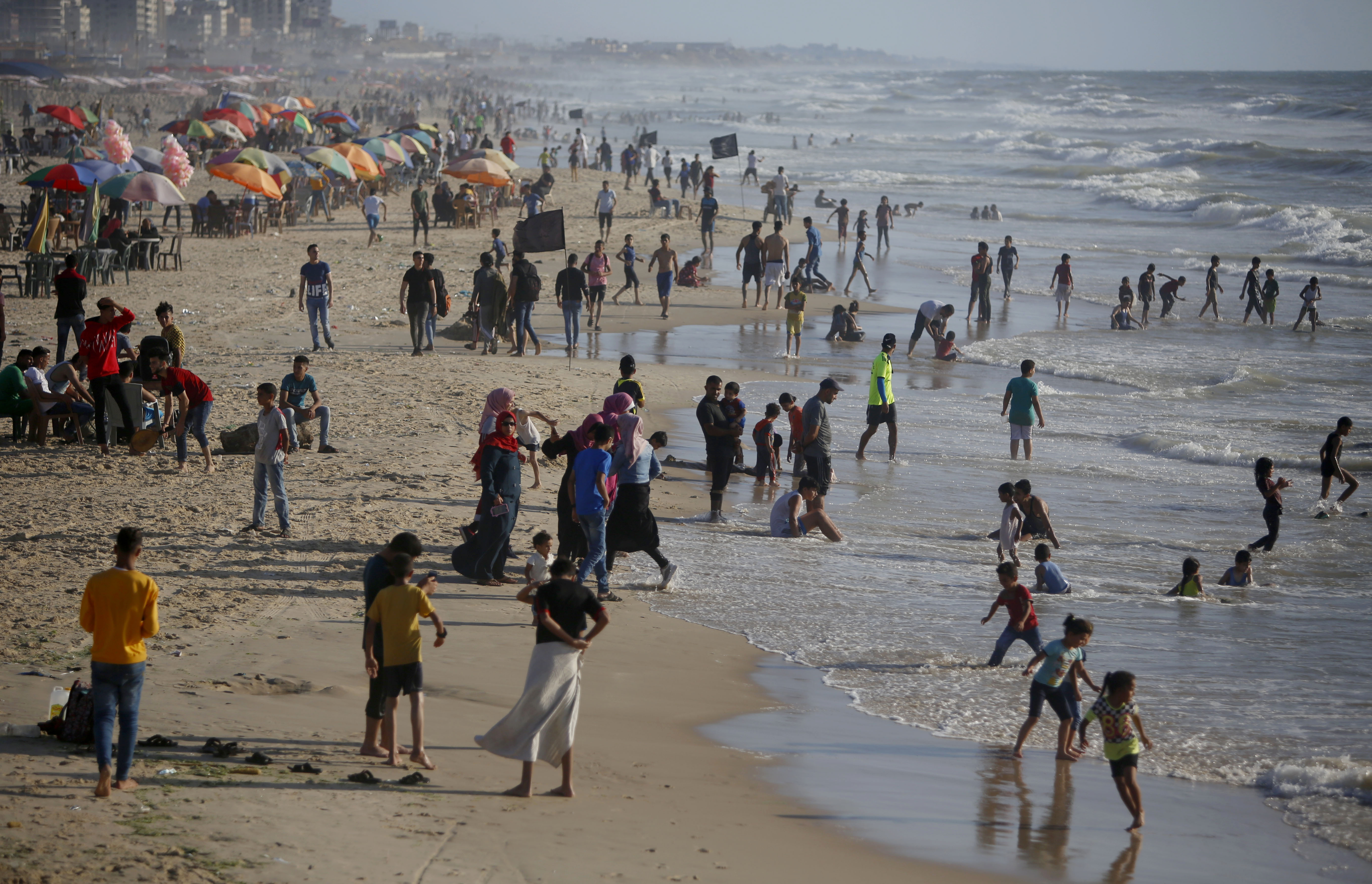 Palestinians enjoy the beach of the Mediterranean sea in Gaza City, Friday, June 19, 2020. The beach is one of the few open public spaces in this densely populated city. (AP Photo/Hatem Moussa)