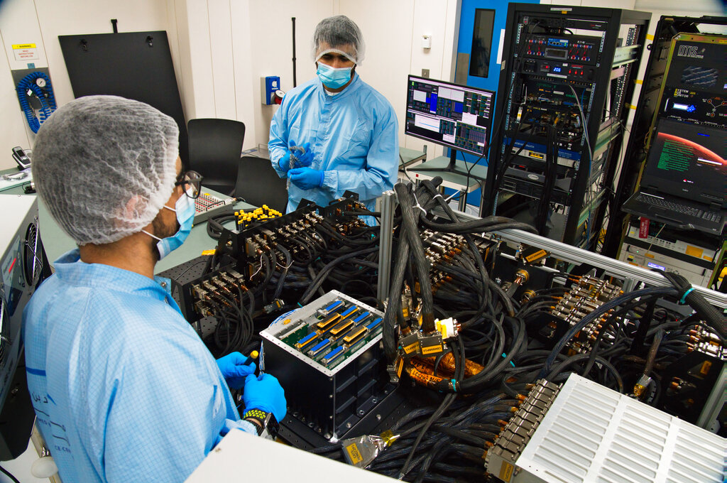 Mahmood al-Nasser, left, and Mohammad Nasser al-Emadi, center, test the Emirates Mars Mission probe's 