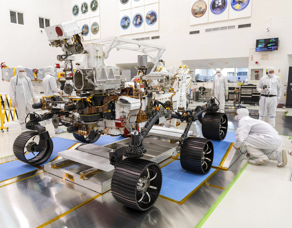 FILE - In this Dec. 17, 2019 photo made available by NASA, engineers monitor a driving test for the Mars rover Perseverance in a clean room at the Jet Propulsion Laboratory in Pasadena, Calif. The robotic vehicle, scheduled to launch on July 30, 2020, is planned to touch down in an ancient river delta and lake known as Jezero Crater, not quite as big as Florida’s Lake Okeechobee. (J. Krohn/NASA via AP, File)