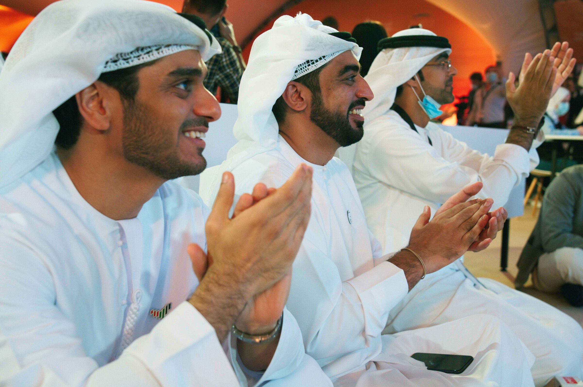 Emirati men claps as they watch the launch of the "Amal" or "Hope" space probe at the Mohammed bin Rashid Space Center in Dubai, United Arab Emirates, Monday, July 20, 2020. A United Arab Emirates spacecraft, the "Amal" or "Hope" probe, blasted off to Mars from Japan early Monday, starting the Arab world's first interplanetary trip. (AP Photo/Jon Gambrell)