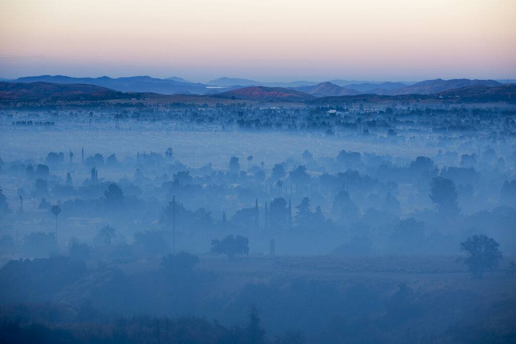 Smoke from the Apple Fire covers the city in Banning, Calif., Saturday, Aug. 1, 2020. (AP Photo/Ringo H.W. Chiu)