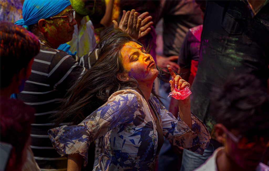 Indians dance and throw colored powder during Holi festival celebrations in Gauhati, India, Tuesday, March 10, 2020. The festival heralds the arrival of spring. (AP Photo/Anupam Nath)