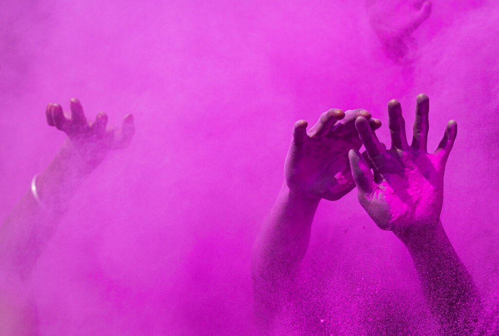 Indians dance and throw colored powder during Holi festival celebrations in Gauhati, India, Tuesday, March 10, 2020. The festival heralds the arrival of spring. (AP Photo/Anupam Nath)