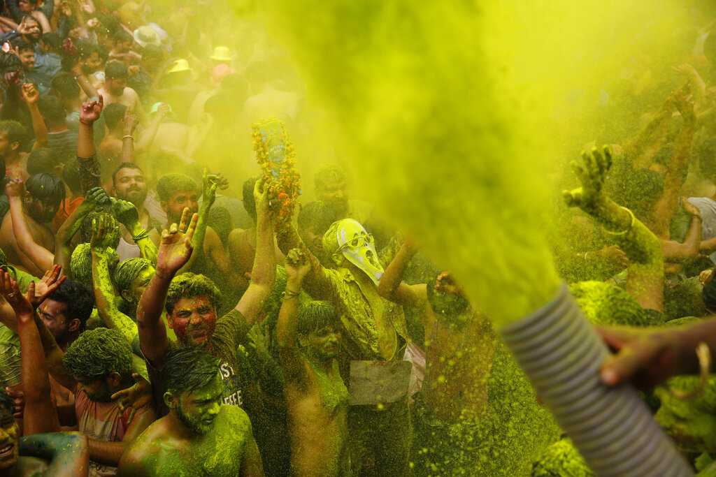 Indians spray color and dance during celebrations marking Holi, the Hindu festival of colors, in Prayagraj, India, Tuesday, March 10, 2020. (AP Photo/Rajesh Kumar Singh)