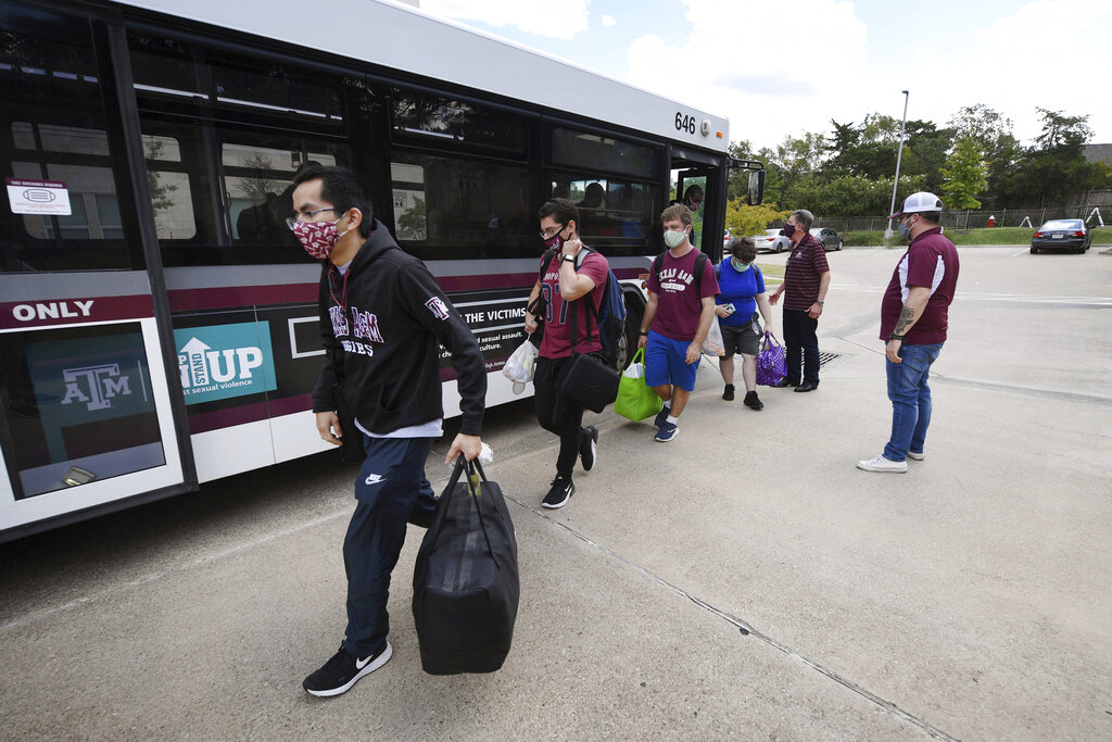 Evacuated students from Texas A&M University at Galveston arrive by bus at Aloft College Station on Tuesday, Aug. 25, 2020, in College Station, Texas. Hurricane Laura is expected to make landfall late Wednesday or early Thursday./College Station Eagle via AP)