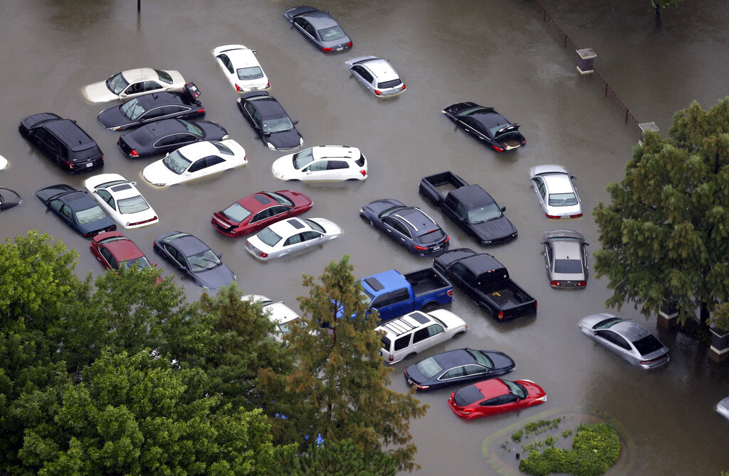 FILE - In this Aug. 29, 2017, file photo, cars are flooded near the Addicks Reservoir as floodwaters from Harvey rise in Houston. Nasty hurricanes that cause billions of dollars in damage are hitting more often. Laura, which is threatening the U.S. Gulf Coast, is only the latest. (AP Photo/David J. Phillip, File)
