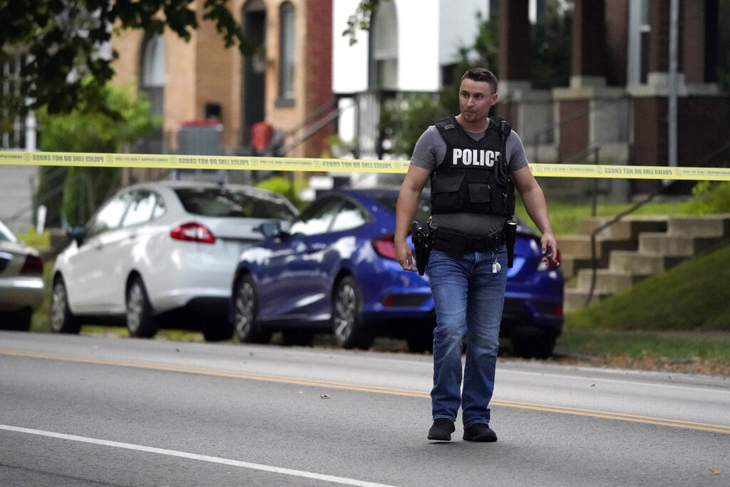 Police work near the scene of a shooting Saturday, Aug. 29, 2020, in St. Louis. The St. Louis Police Department says two of their officers have been shot and a suspect is believed to be barricaded in a house nearby. (AP Photo/Jeff Roberson)