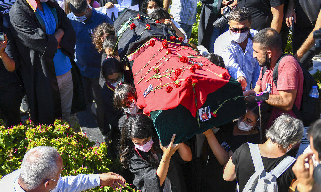 People carry the coffin of Ebru Timtik, a human rights lawyer who died during a hunger strike in a Turkish prison to demand a fair trial for herself and colleagues, in Istanbul, Friday, Aug. 28, 2020. Timtik, 42, died in an Istanbul hospital late Thursday, the Progressive Lawyers' Association said. She had been fasting for 238 days. (AP Photo)