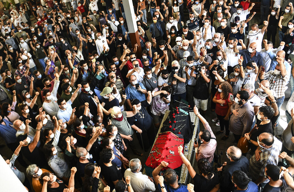 People carry the coffin of Ebru Timtik, a human rights lawyer who died during a hunger strike in a Turkish prison to demand a fair trial for herself and colleagues, in Istanbul, Friday, Aug. 28, 2020. Timtik, 42, died in an Istanbul hospital late Thursday, the Progressive Lawyers' Association said. She had been fasting for 238 days.(AP Photo)