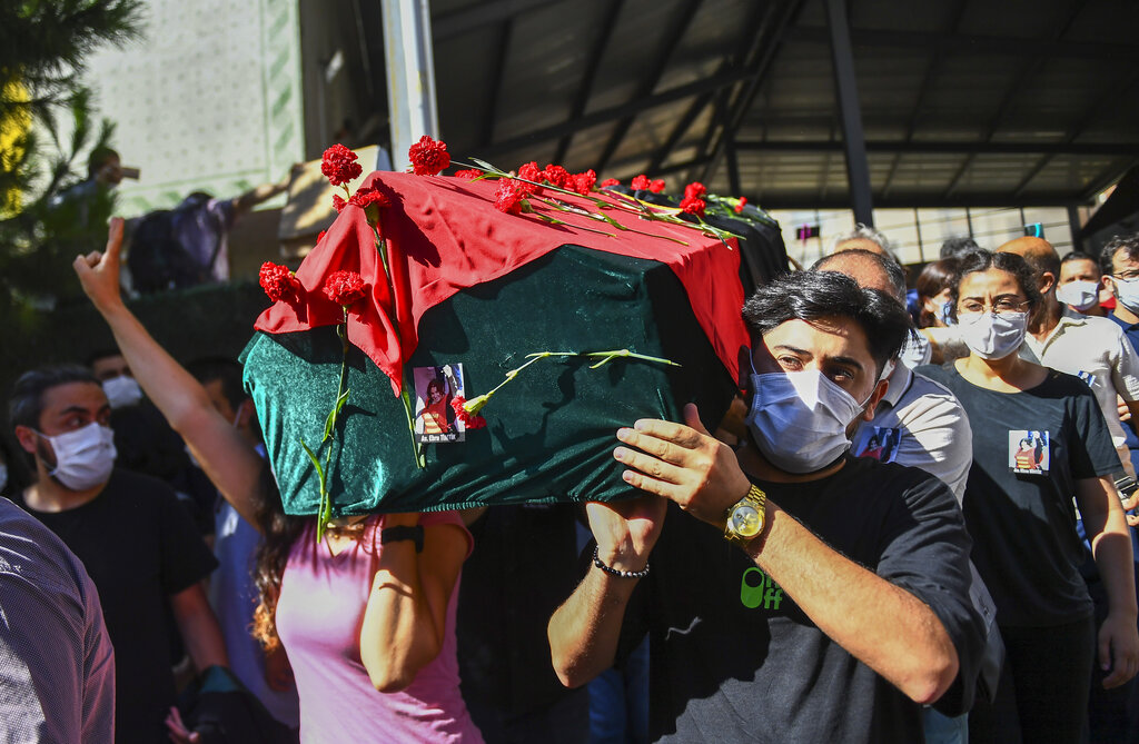 People carry the coffin of Ebru Timtik, a human rights lawyer who died during a  hunger strike in a Turkish prison to demand a fair trial for herself and colleagues, in Istanbul, Friday, Aug. 28, 2020. Timtik, 42, died in an Istanbul hospital late Thursday, the Progressive Lawyers' Association said. She had been fasting for 238 days.(AP Photo)