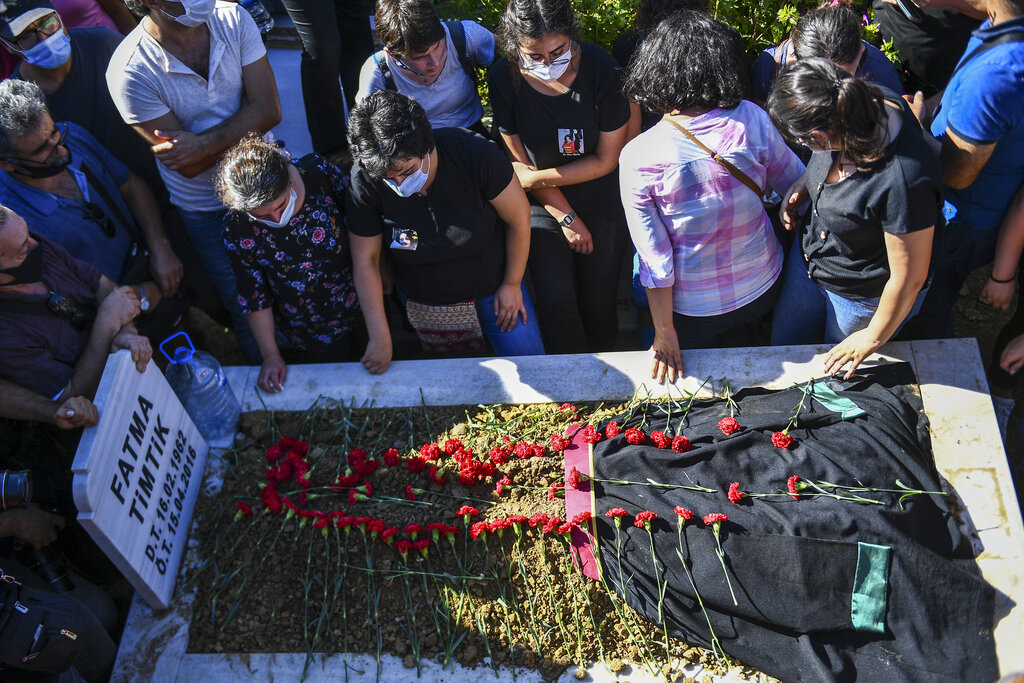 People mourn as they attend the funeral of Ebru Timtik, a human rights lawyer who died during a  hunger strike in a Turkish prison to demand a fair trial for herself and colleagues, in Istanbul, Friday, Aug. 28, 2020. Timtik, 42, died in an Istanbul hospital late Thursday, the Progressive Lawyers' Association said. She had been fasting for 238 days.(AP Photo)