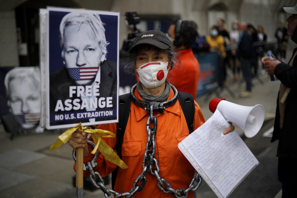A supporter of WikiLeaks founder Julian Assange takes part in a protest outside the Central Criminal Court, the Old Bailey in London, Monday, Sept. 7, 2020. Lawyers for WikiLeaks founder Julian Assange and the U.S. government were squaring off in a London court on Monday at a high-stakes extradition case delayed by the coronavirus pandemic. American prosecutors have indicted the 49-year-old Australian on 18 espionage and computer misuse charges over the WikiLeaks publication of secret U.S. military documents a decade ago. The charges carry a maximum sentence of 175 years in prison. (AP Photo/Matt Dunham)