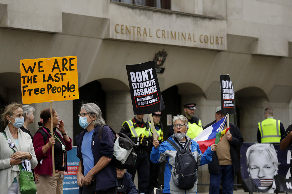 Supporters of WikiLeaks founder Julian Assange take part in a protest outside the Central Criminal Court, the Old Bailey in London, Monday, Sept. 7, 2020. Lawyers for WikiLeaks founder Julian Assange and the U.S. government were squaring off in a London court on Monday at a high-stakes extradition case delayed by the coronavirus pandemic. American prosecutors have indicted the 49-year-old Australian on 18 espionage and computer misuse charges over the WikiLeaks publication of secret U.S. military documents a decade ago. The charges carry a maximum sentence of 175 years in prison. (AP Photo/Matt Dunham)