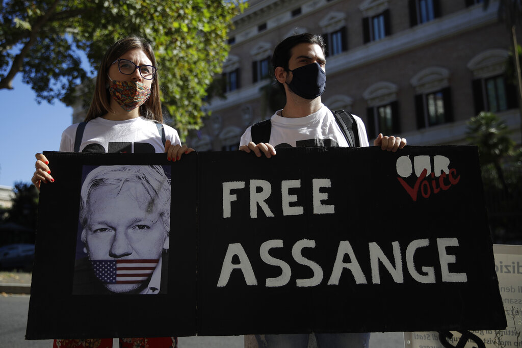 Protestors hold a placard reading Free Assange outside the United States Embassy in Rome, Monday, Sept. 7, 2020. Lawyers for WikiLeaks founder Julian Assange and the U.S. government were squaring off in a London court on Monday at a high-stakes extradition case delayed by the coronavirus pandemic. American prosecutors have indicted the 49-year-old Australian on 18 espionage and computer misuse charges over Wikileaks' publication of secret U.S. military documents a decade ago. (AP Photo/Alessandra Tarantino)