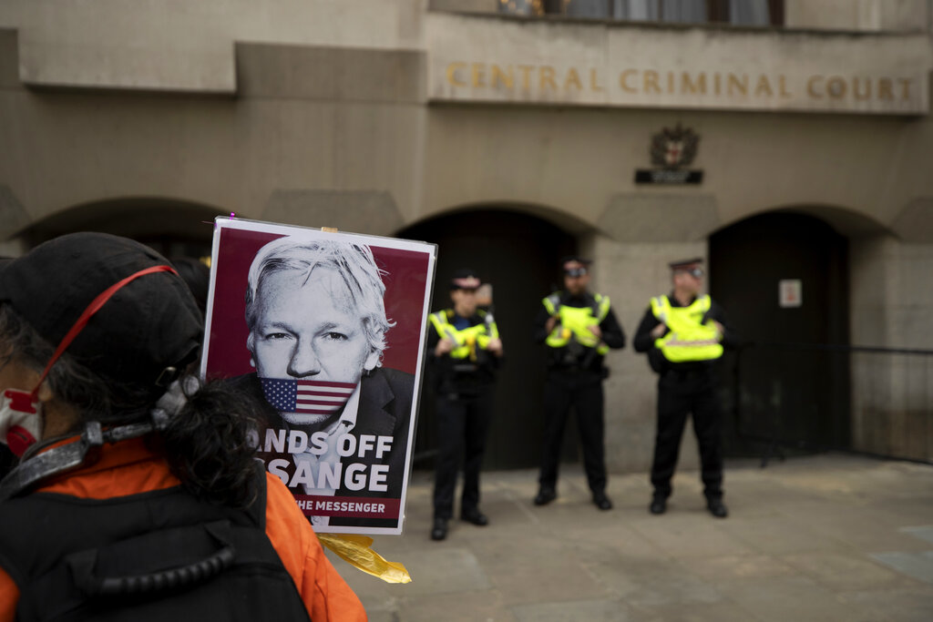 A supporter of WikiLeaks founder Julian Assange takes part in a protest outside the Central Criminal Court, the Old Bailey in London, Monday, Sept. 7, 2020. Lawyers for WikiLeaks founder Julian Assange and the U.S. government were squaring off in a London court on Monday at a high-stakes extradition case delayed by the coronavirus pandemic. American prosecutors have indicted the 49-year-old Australian on 18 espionage and computer misuse charges over the WikiLeaks publication of secret U.S. military documents a decade ago. The charges carry a maximum sentence of 175 years in prison. (AP Photo/Matt Dunham)