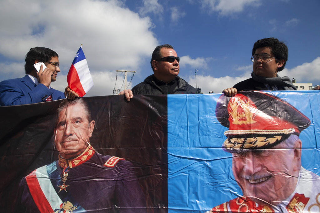 A small group of supporters of late Chilean dictator Gen. Augusto Pinochet show their support for him, on the anniversary of the 1973 coup that carried Pinochet into power, in Santiago, Chile, Wednesday, Sept. 11, 2019. The 1973 military coup ousted democratically elected President Salvador Allende and began the 17-year dictatorship of Gen. Pinochet. (AP Photo/Esteban Felix)