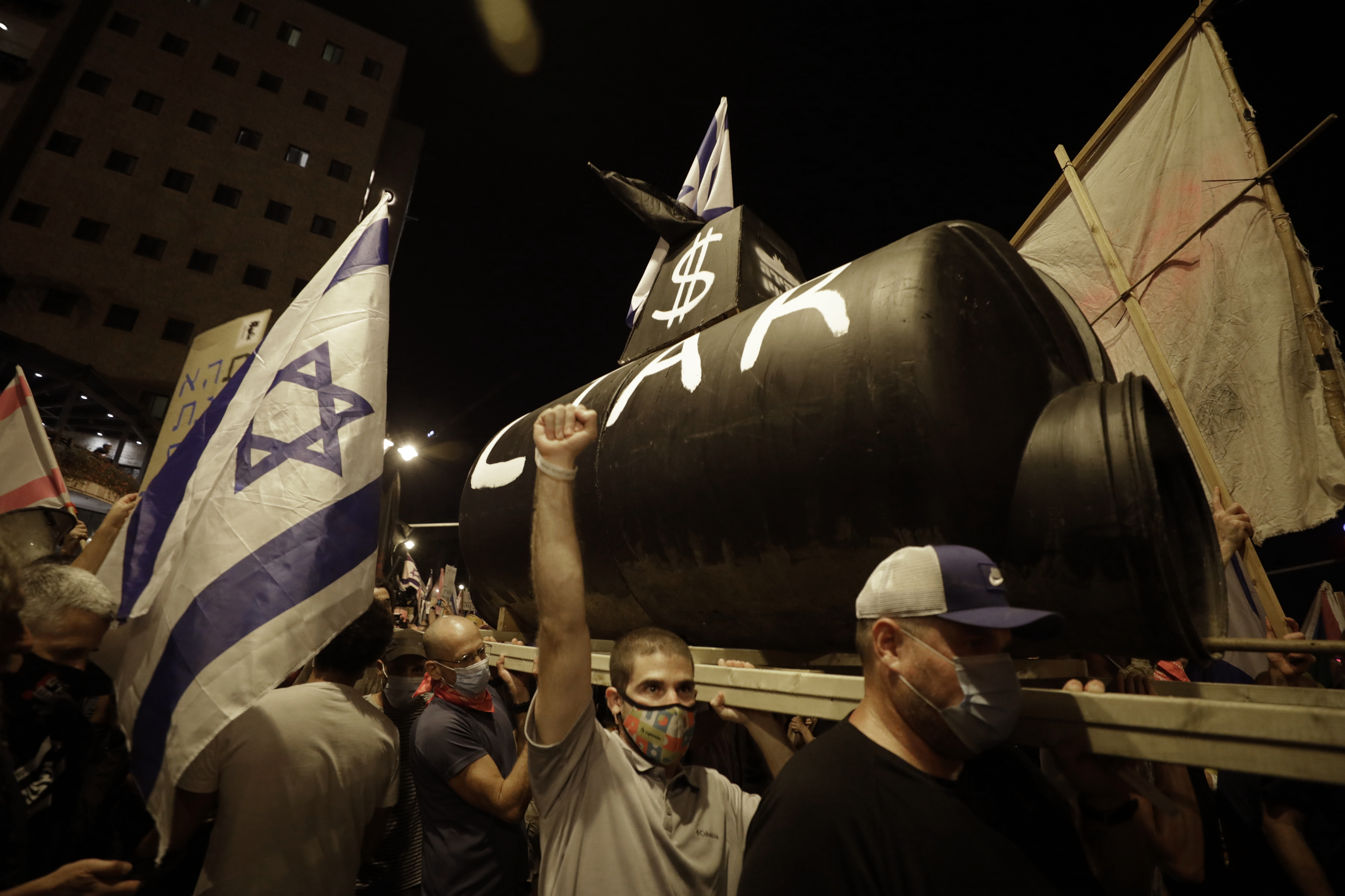 Israeli protesters chant slogans during a demonstration against Israeli Prime Minister Benjamin Netanyahu outside the Prime Minister's residence in Jerusalem, Saturday, Sept. 12, 2020. (AP Photo/Sebastian Scheiner)