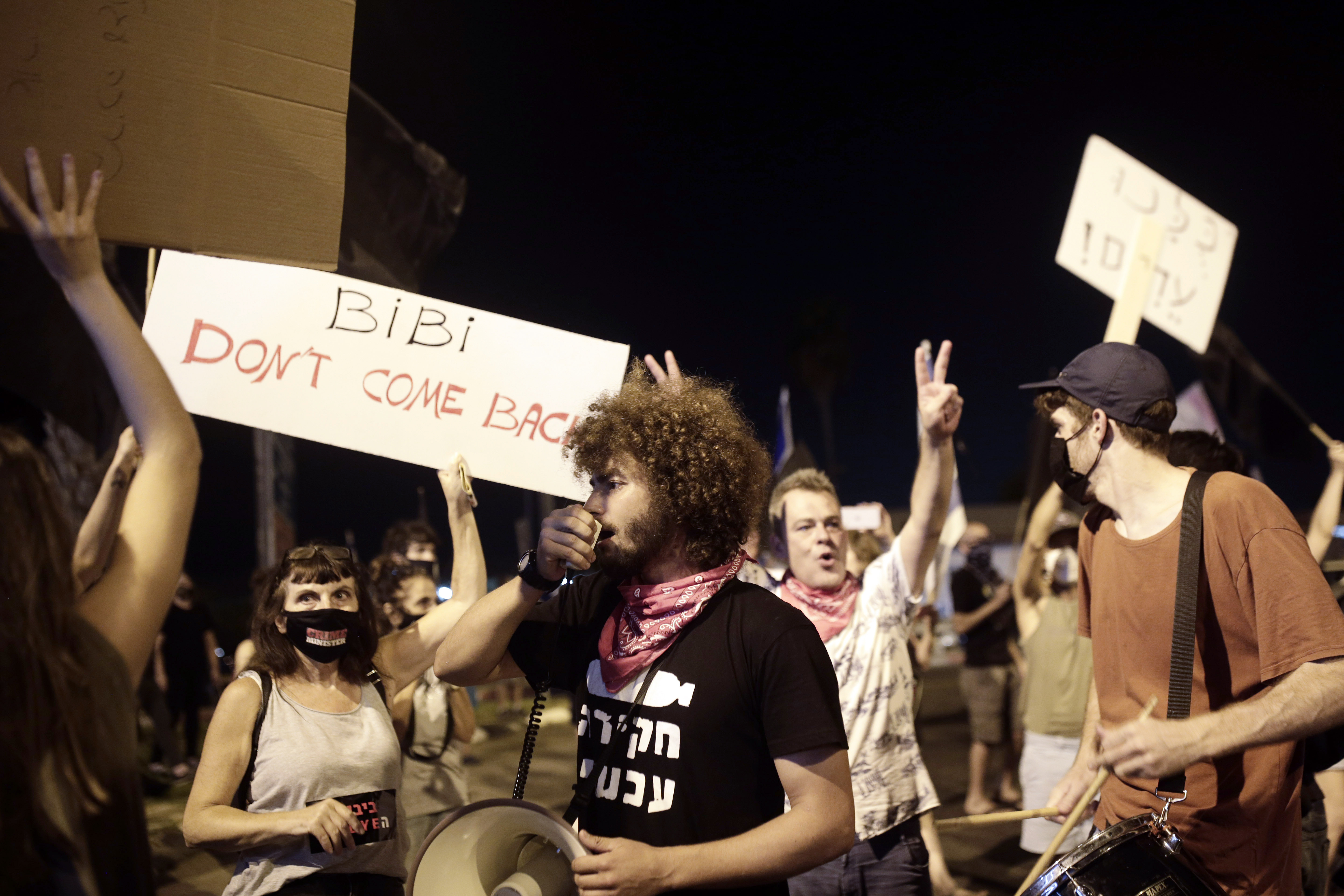 Protesters block an entrance to Ben Gurion Airport where Prime Minister Benjamin Netanyahu and his family are expected to fly with an Israeli delegation to the U.S. for a ceremony with the United Arab Emirates, in Tel Aviv, Sunday, Sept. 13, 2020. (AP Photo/Maya Alleruzzo)