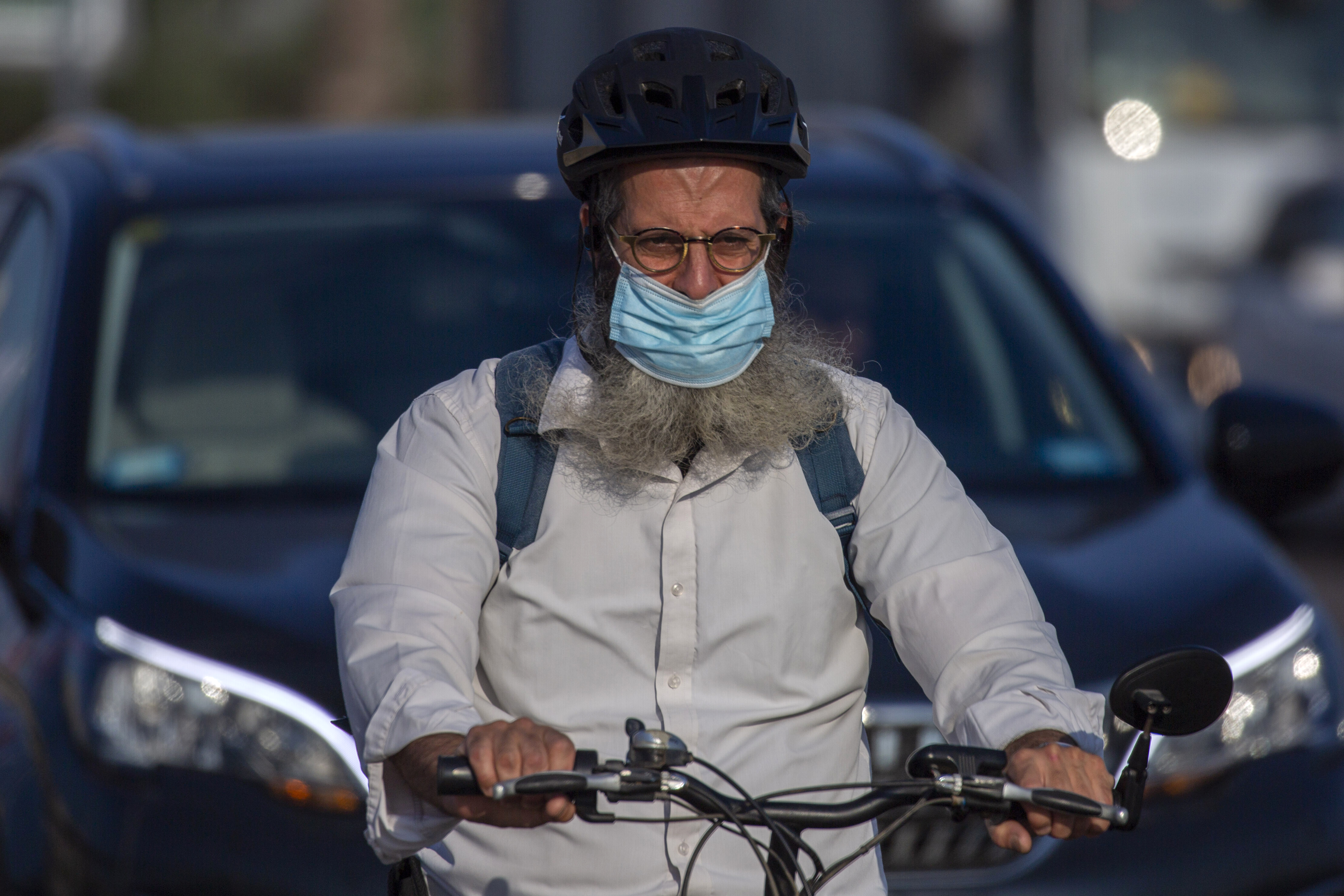A man wears a face mask against the coronavirus pandemic in Netanya Netanya, Israel, Monday, Sept. 14, 2020. Israel will reinstate a strict new countrywide lockdown this week amid a stubborn surge in coronavirus cases. (AP Photo/Ariel Schalit)