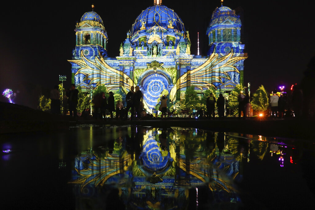 The Berlin Cathedral is illuminated during the 'Festival of Lights' event in Berlin, Germany, Friday, Sept. 11, 2020. Berlin's most famous landmarks and buildings will be glowing and sparkling with various colours and types of light and projections during the festival, which runs from Friday Sept. 11 until Sunday, Sept. 20, 2020, at the German capital. (AP Photo/Markus Schreiber)
