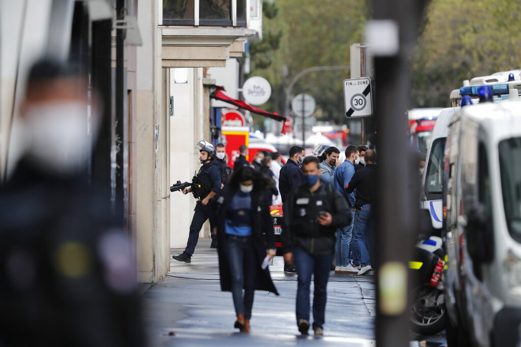 French police officers patrol the area after a knife attack near the former offices of satirical newspaper Charlie Hebdo, Friday Sept. 25, 2020 in Paris. Paris police say they have arrested a man suspected of a knife attack that wounded at least two people near the former offices of satirical newspaper Charlie Hebdo. Police initially thought there were two attackers but now say there was only one.  (AP Photo/Thibault Camus)