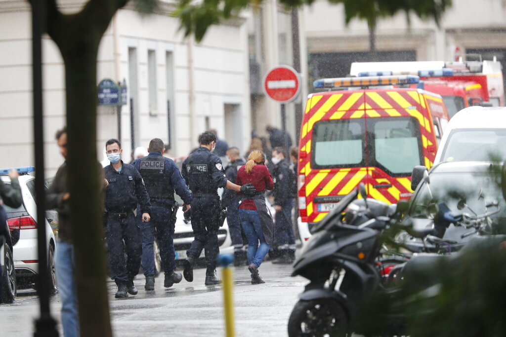 French police officers patrol the area after a knife attack near the former offices of satirical newspaper Charlie Hebdo, Friday Sept. 25, 2020 in Paris. Paris police say they have arrested a man suspected of a knife attack that wounded at least two people near the former offices of satirical newspaper Charlie Hebdo. Police initially thought there were two attackers but now say there was only one.  (AP Photo/Thibault Camus)