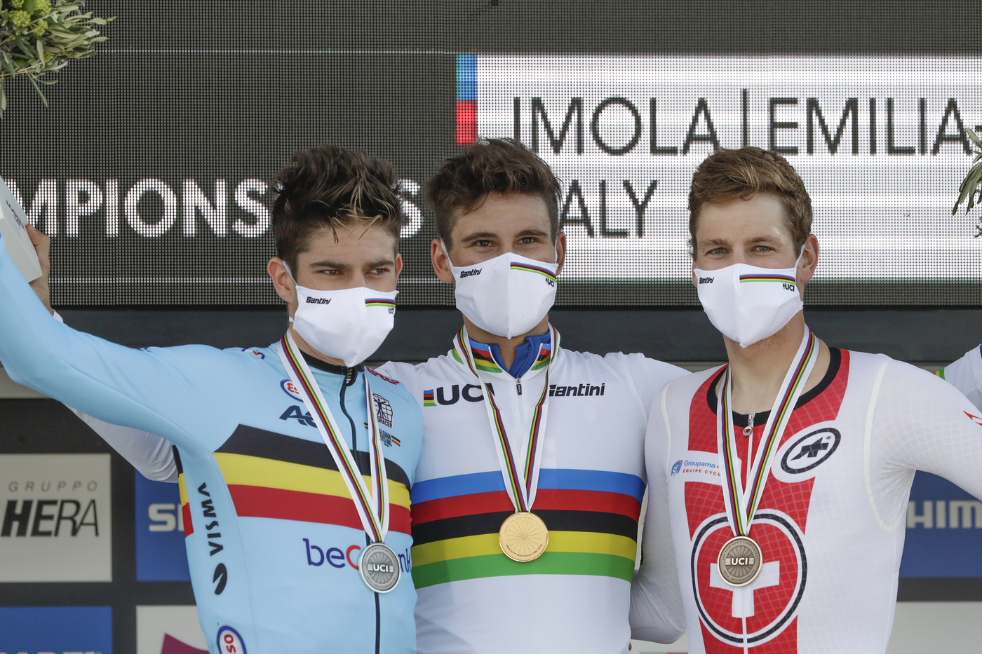 Italy's Filippo Ganna, center, winner of the men's Individual Time Trial event, poses on the podium with second placed Belgium's Wout van Aert, left, and third placed Switzerland's Stefan Kung, at the road cycling World Championships, in Imola, Italy, Friday, Sept. 25, 2020. (AP Photo/Andrew Medichini)