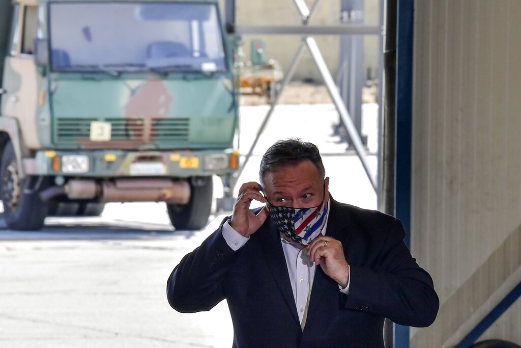 US Secretary of State Mike Pompeo adjusts his face mask during his visit at the Naval Support Activity base at Souda, on the Greek island of Crete, Tuesday, Sept. 29, 2020. Pompeo visited a U.S. naval base at Souda Bay on the southern Greek island of Crete Tuesday, ahead of a meeting with Greece's prime minister on the second day of his trip to the country. (Aris Messinis/Pool viaAP)