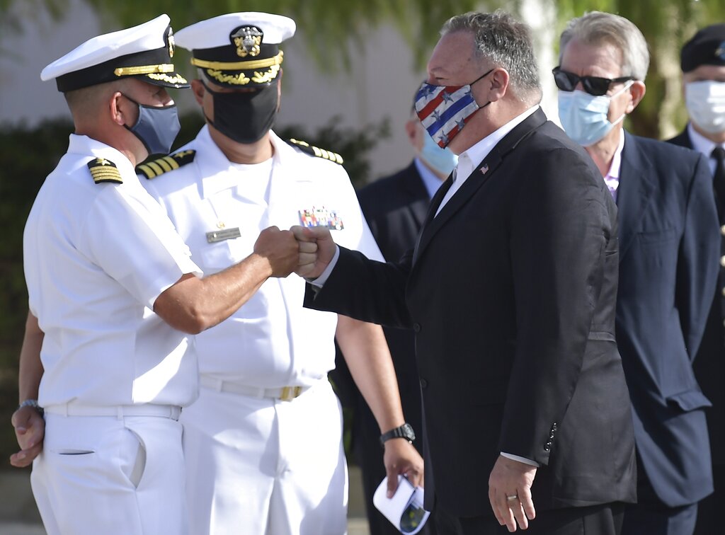 US Secretary of State Mike Pompeo, right, touch elbows with a Naval officer during his visit at the Naval Support Activity base at Souda, on the Greek island of Crete, Tuesday, Sept. 29, 2020. Pompeo is visiting the U.S. naval base ahead of a meeting with Greece's prime minister on the second day of his trip to the country. (Aris Messinis/Pool viaAP)