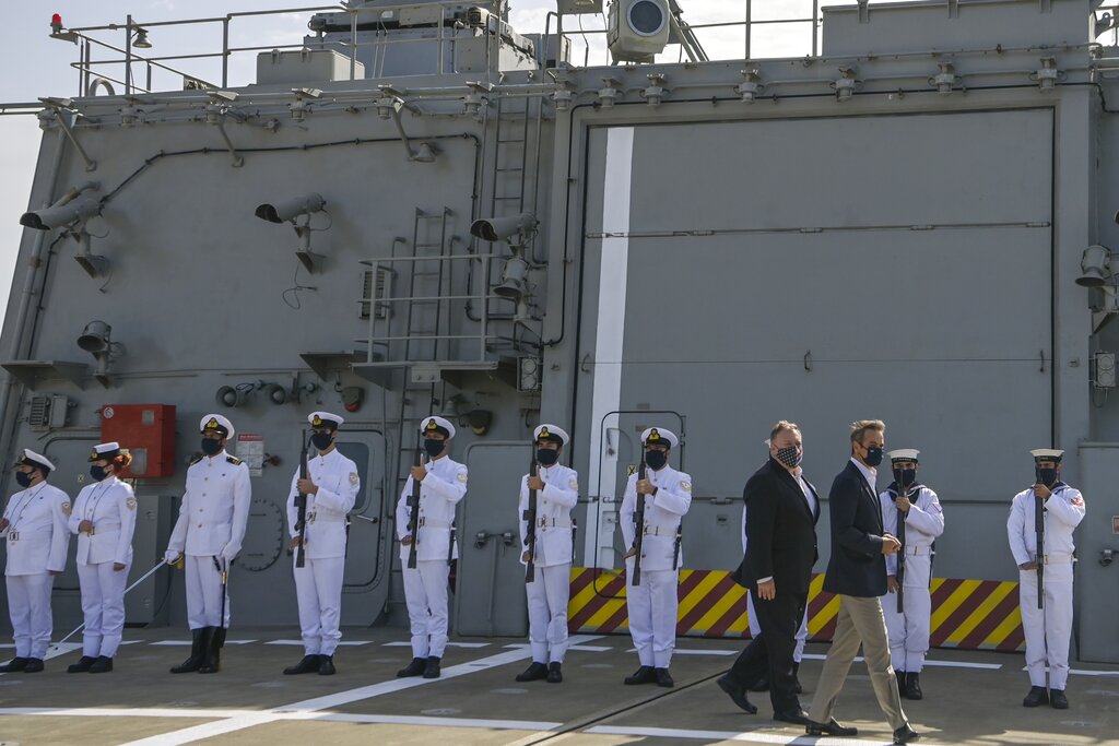 US Secretary of State Mike Pompeo, left, and Greek Prime Minister Kyriakos Mitsotakis visit the Greek frigate Salamis at the Naval Support Activity base at Souda, on the Greek island of Crete, Tuesday, Sept. 29, 2020. Pompeo visited a U.S. naval base at Souda Bay on the southern Greek island of Crete Tuesday, ahead of a meeting with Greece's prime minister on the second day of his trip to the country. (Aris Messinis/Pool viaAP)